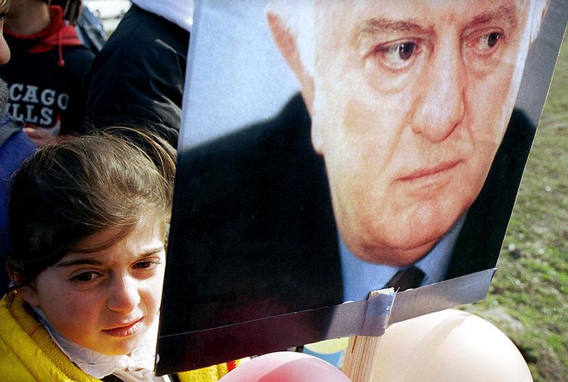 GIRL HOLDS SHEVARDNADZE PLACARD AT RALLY IN TBILISI.