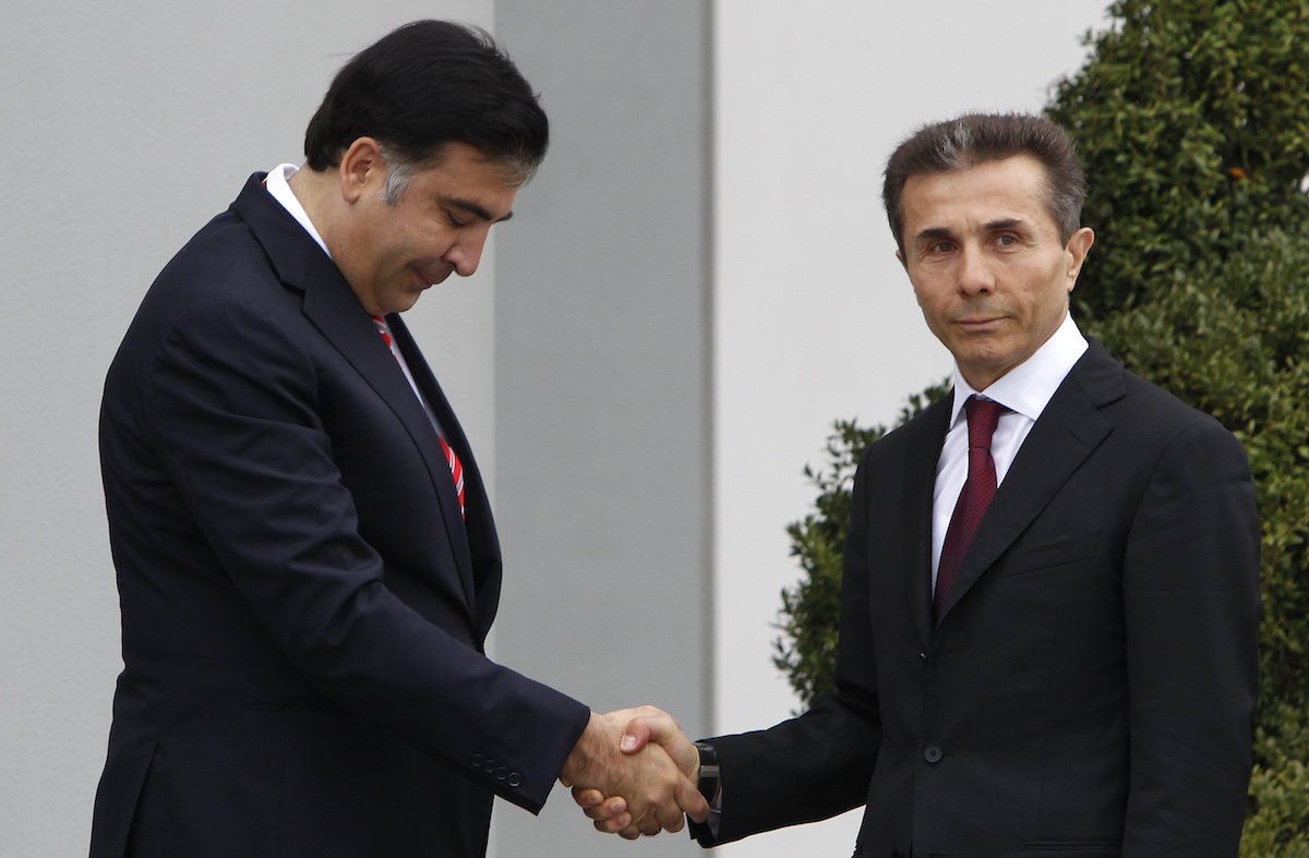 Georgian President Mikheil Saakashvili and head of the winning Georgian Dream party Bidzina Ivanishvili. October 2012. REUTERS/David Mdzinarishvili