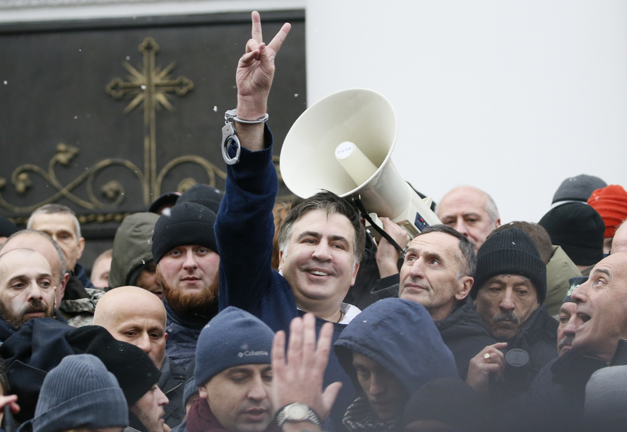Georgian former President Mikheil Saakashvili flashes a victory sign after he was freed by his supporters in Kiev
