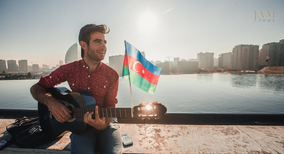 A boy playing guitar. Azerbaijani flag