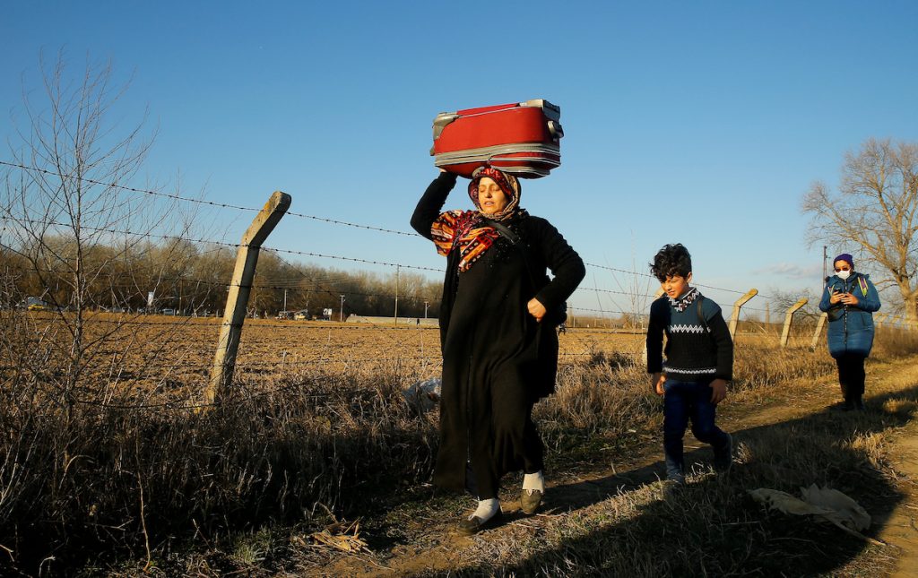 Uşaqları ilə birlikdə Yunanıstanın Kastanis məntəqəsindən Türkiyənin Pazarkule sərhəd-keçid məntəqəsinə gələn qaçqın qadın çamadanını başında daşıyır. 28 fevral, 2020. REUTERS / Huseyin Aldemir. Suriyalı və əfqan qaçqınlar Türkiyədə