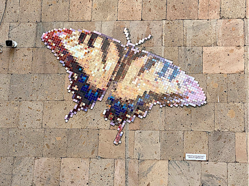 Mosaic and graffiti butterflies in Armenia. Post-war butterfly in Yerevan, near the Center for Contemporary Experimental Art