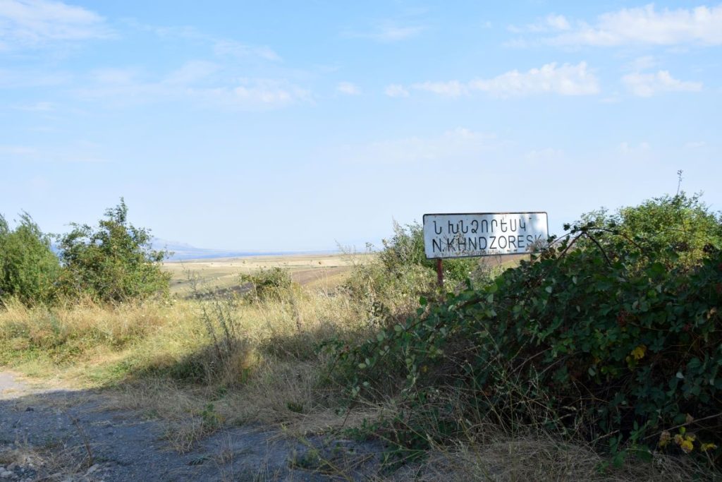 A sign at the entrance to the village. Photo: JAMnews
