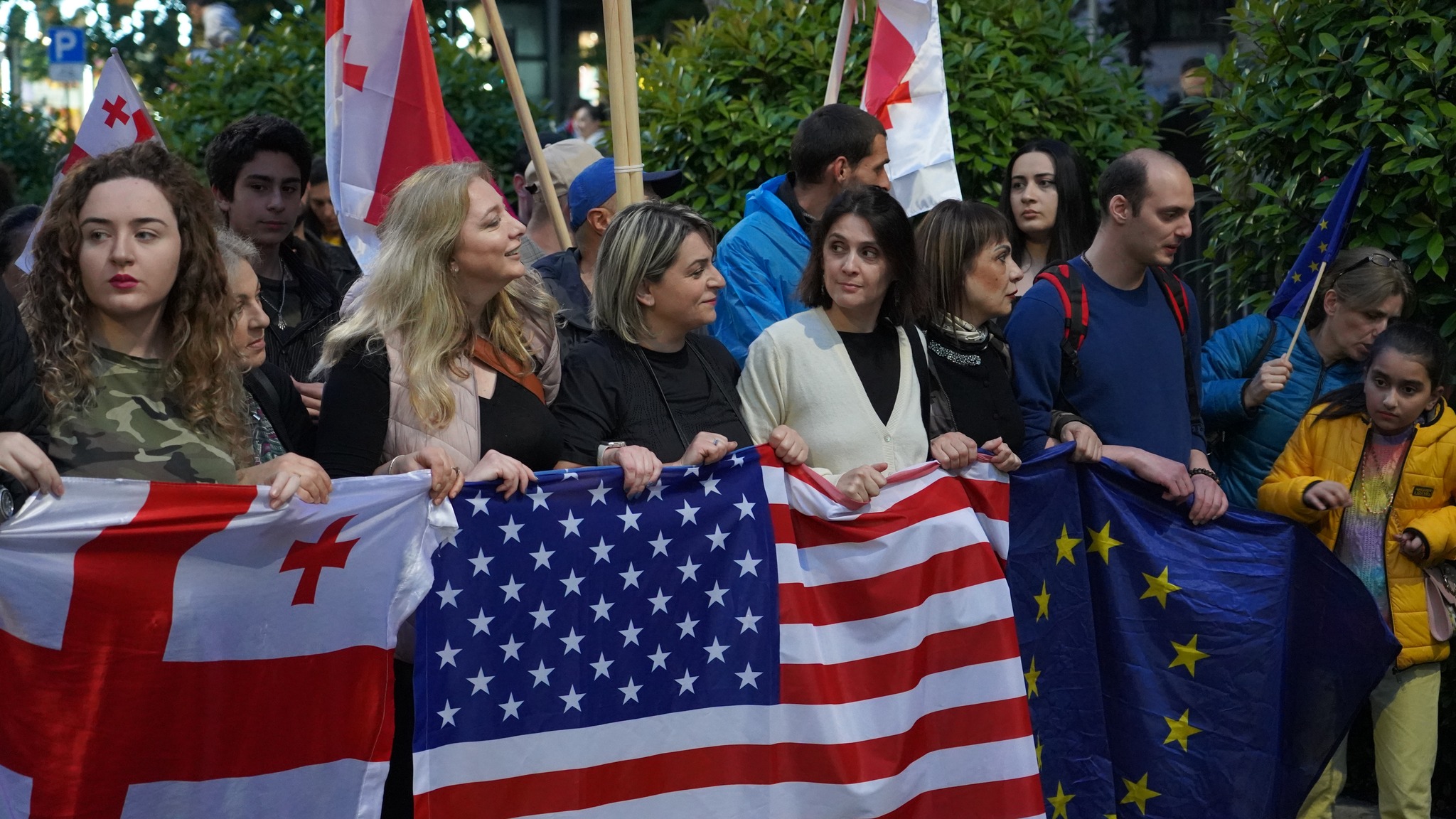 Georgian, US and EU flags at the demonstration against Agents Law. Photo: David Pipia